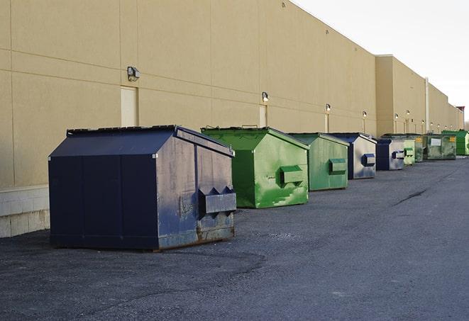 tilted front-load dumpsters being emptied by waste management workers in Anacortes